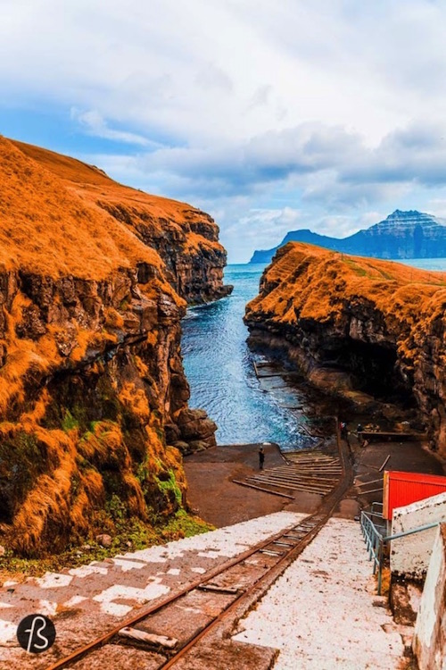 The gorge that gives name to the village is one of the best natural harbors in the Faroe Islands. But things are not that simple. Boats need to be pulled up on a ramp to keep them safe from the water. During the night, there are colorful lights all around and they make the gorge even more beautiful. An amazing opportunity to take even more pictures. 