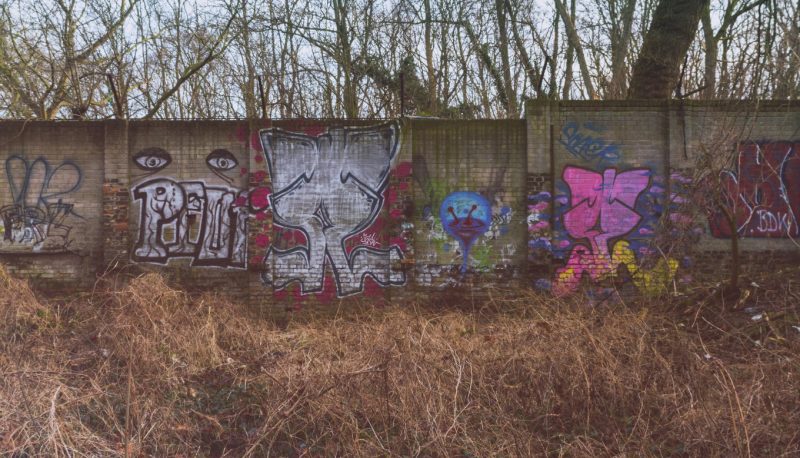 Back in 1999, local historian Christian Bormann found something that it wasn’t supposed to be lost. Nine years after demolition began, he found a piece of the Berlin Wall, somehow forgotten in the woods between a train station and a supermarket. More than 80 meters of the original Berlin Wall, built in 1961, is standing there, some with the V-shaped brackets that once had barbed wire on it. It’s hard to believe that something with this historical importance was lost and this is why we went there to see it with our own eyes.