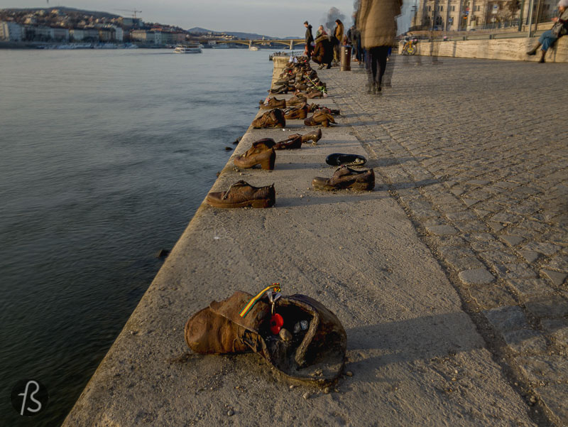When you walk along the Danube Promenade, next to the Hungarian Parliament Building, you will find a memorial called Shoes on the Danube Bank. The monument was conceived by Can Togay, with the help from sculptor Gyula Pauer, to remember and honor the Jews that were murdered by Arrow Cross, a fascist militia, during the last months of the Second World War in Budapest.