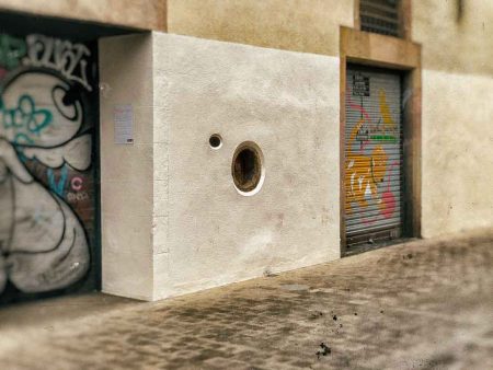 Hiding in plain sight, in the middle of El Raval, there is a small wooden door that was once attached to the Provincial Home for Maternity and Foundlings of Barcelona. Nowadays, that small round door looks more like a decoration than anything else, but that is the infamous Barcelona's baby drop-off. And, when we were in Barcelona, we had to visit the location and take pictures of it.