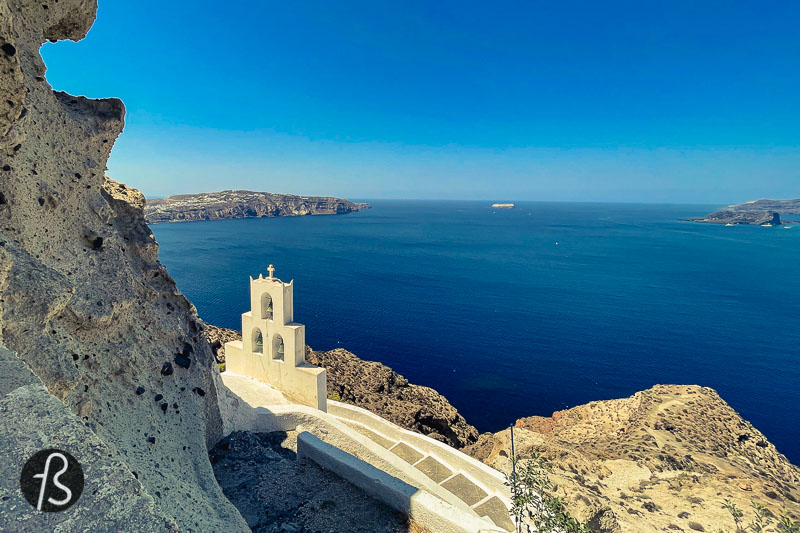 After a few minutes going down the hill, the bell tower of Agios Nikolaos started to appear, like it was being born out of the rocks. Together with the rocky cliff, the chapel looks like scenery made for pictures. The white building that seems like it goes into the cliff, as a chapel built in a cave. The view from there is fantastic, and it was more than worth the unusual hiking route we took down the hill.