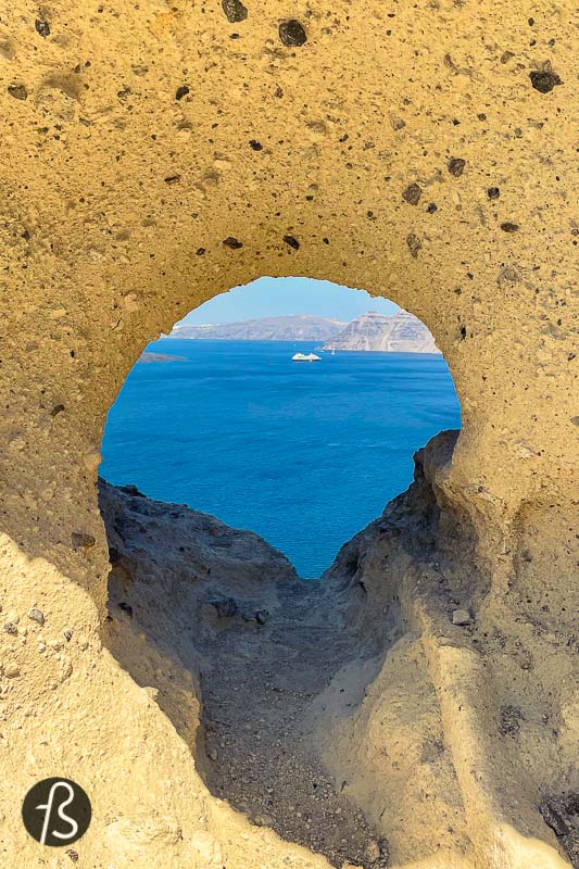 This downhill path led to a cobblestone stair that was made of broad steps. On the right side, there was a hole in the white volcanic ash of the cliff, and, we believe, this is the heart of Santorini. A small cave-like hole that must be an Instagram hotspot for those who decide to wander around and see more than just the towns of Fira and Oia. 