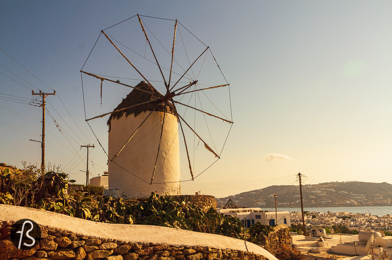 The traditional way of building the windmills of Mykonos is simple. They were all spherical shaped, made of stones sourced locally and a pointed roof at the top made of wood. Today, they are all painted white which blends quite well with the other buildings spread around the island and looks gorgeous in contrast to the blue from the Aegean sea.