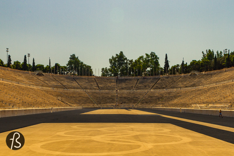 Outside Athens, the Panathenaic Stadium started as a racecourse between two hills and Agra and Ardettos. Next to it, the Ilissos river used to flow, and we can only imagine how idyllic this place used to be in ancient times. Nowadays, the river flows under the Vasileos Konstantinou Avenue, and the atmosphere around the stadium feels quite busy. But, it's still a fantastic place to visit in Athens!