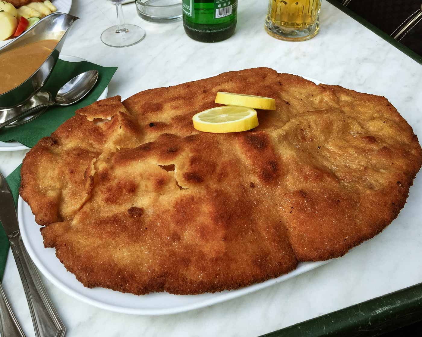 Get ready to conquer Berlin's biggest schnitzel at Louis! This legendary restaurant in historic Rixdorf serves up an epic pork schnitzel that's over a kilo. Discover the taste of tradition and challenge your appetite.