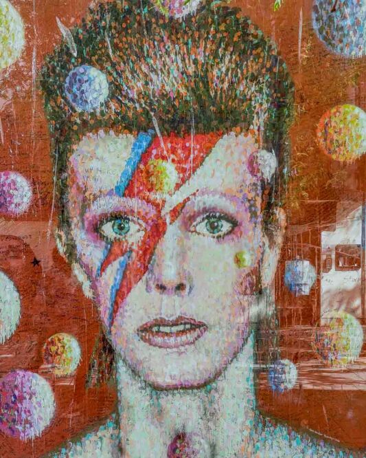 In the heart of Brixton, the neighborhood where David Bowie was born and raised, a vibrant mural captures the essence of his flamboyant personality. Located on the side of Morley's Department Store, opposite the Brixton tube station, this artwork by Australian artist James Cochran depicts David Bowie as his alter ego, Ziggy Stardust. The lightning bolt painted on his face, symbolizing the duality of the mind, has become synonymous with Bowie's image.