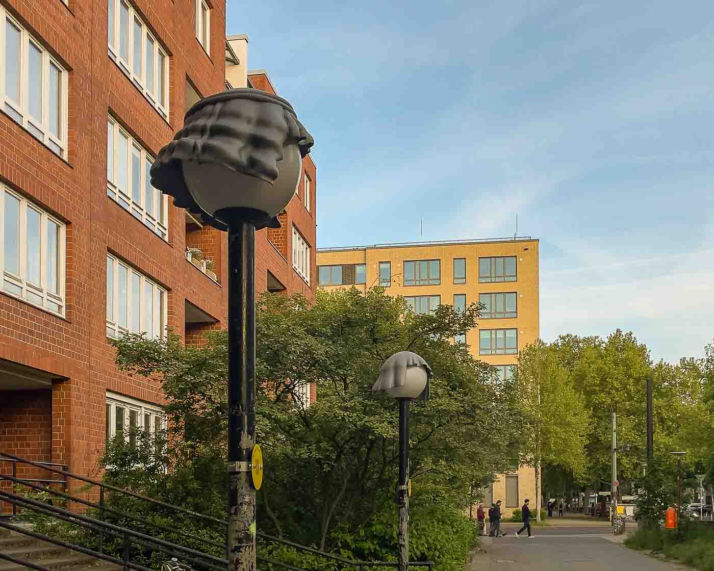 On the border of Mitte and Wedding lies Brunnenviertel, a neighborhood renowned for its inviting green spaces and tranquil, pedestrian-friendly courtyards. As dusk settles, a soft, romantic glow emanates from the area's distinctive spherical streetlamps. But there's a clever twist to that. Look closely, and you'll discover that many of these lamps are wearing hats. These are the Nightcaps, a brilliant public art installation that is both functional and fantastical.