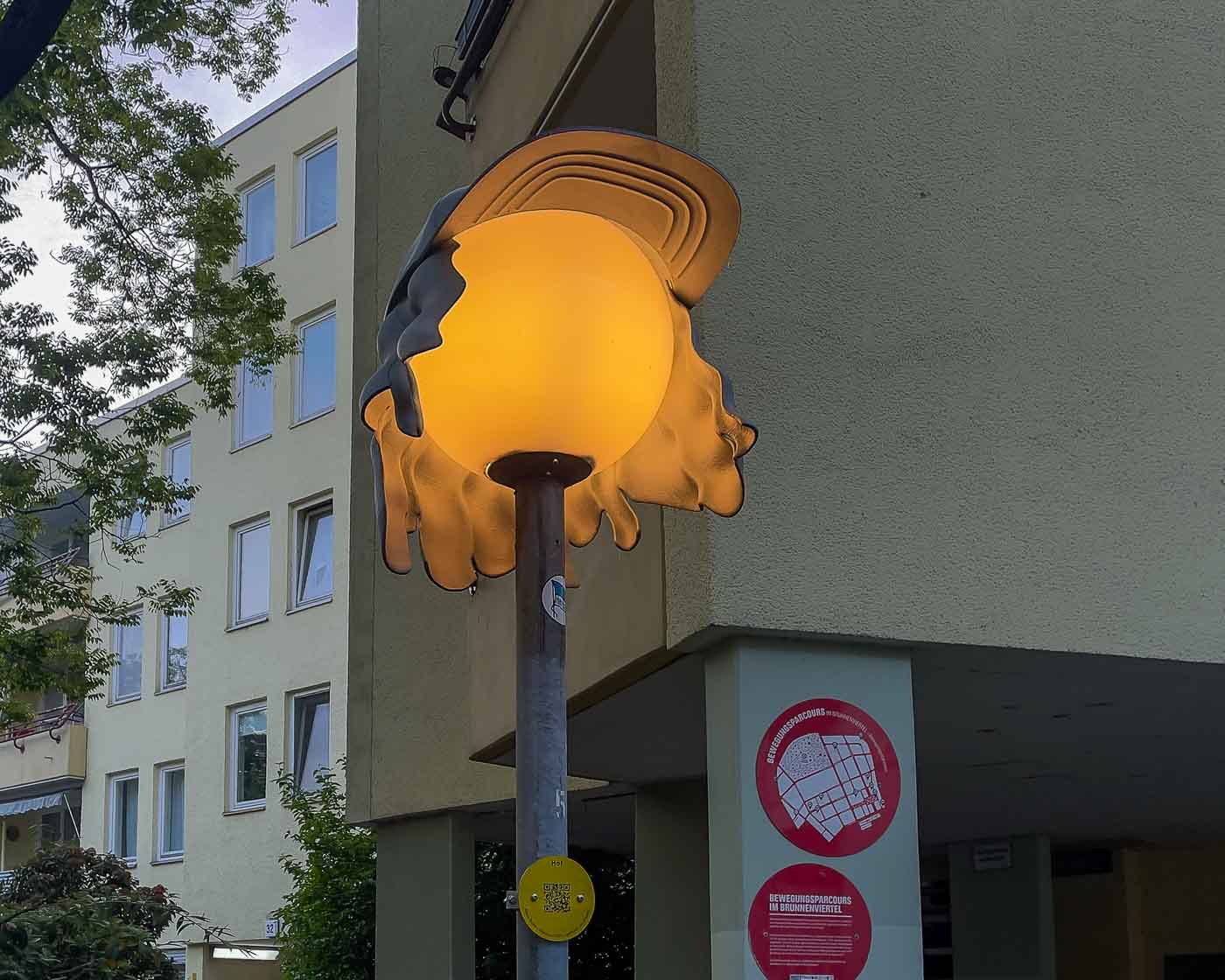 On the border of Mitte and Wedding lies Brunnenviertel, a neighborhood renowned for its inviting green spaces and tranquil, pedestrian-friendly courtyards. As dusk settles, a soft, romantic glow emanates from the area's distinctive spherical streetlamps. But there's a clever twist to that. Look closely, and you'll discover that many of these lamps are wearing hats. These are the Nightcaps, a brilliant public art installation that is both functional and fantastical.