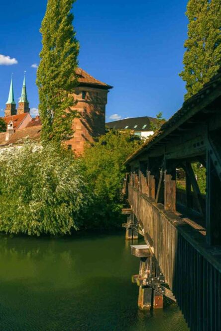 There are several wooden bridges crossing from one side to the other in the heart of Nuremberg. For one of the most romantic and photogenic river views, you have to find the Henkersteg, a historic wooden walkway spanning the Pegnitz River.