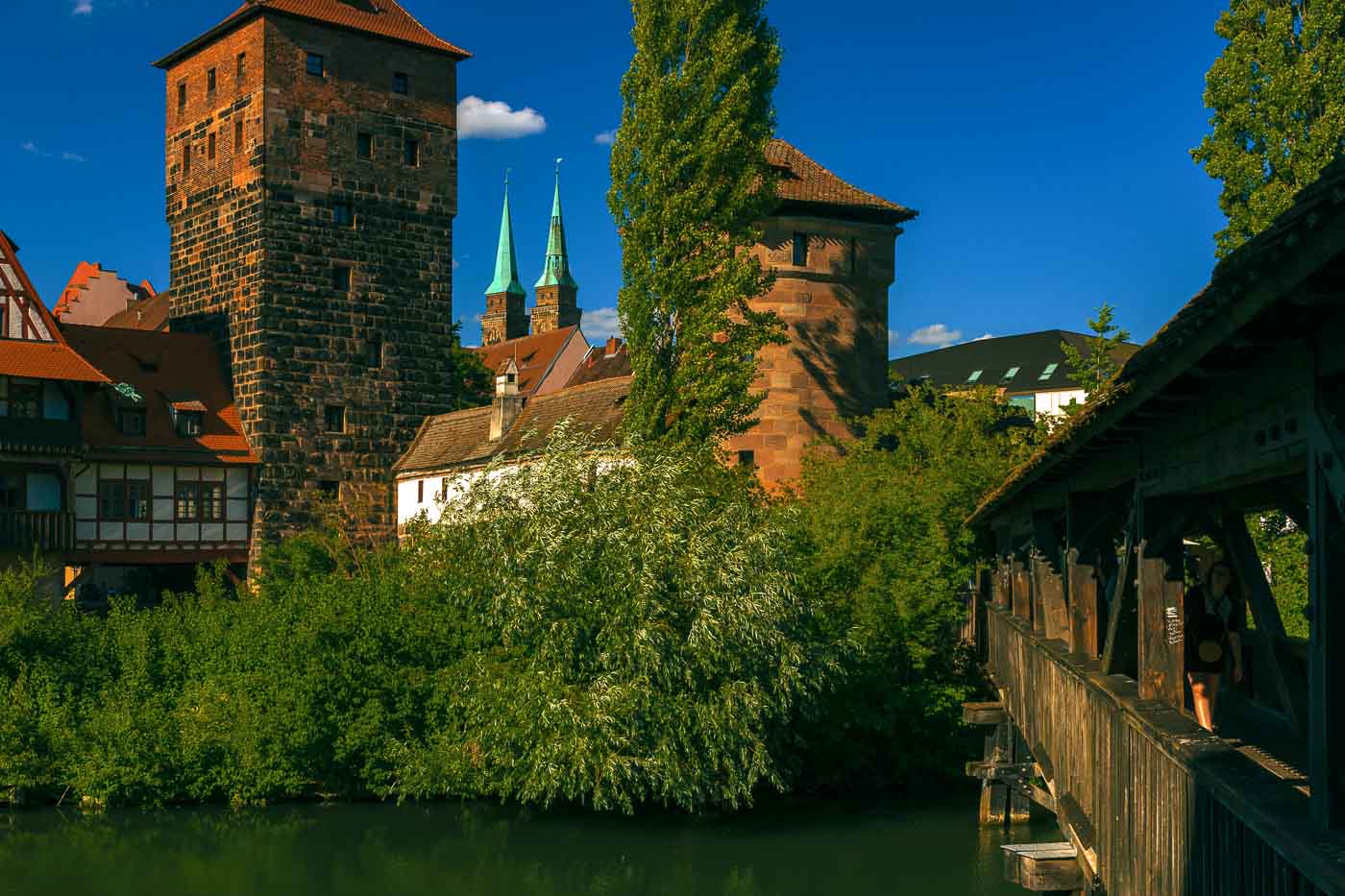 There are several wooden bridges crossing from one side to the other in the heart of Nuremberg. For one of the most romantic and photogenic river views, you have to find the Henkersteg, a historic wooden walkway spanning the Pegnitz River. 