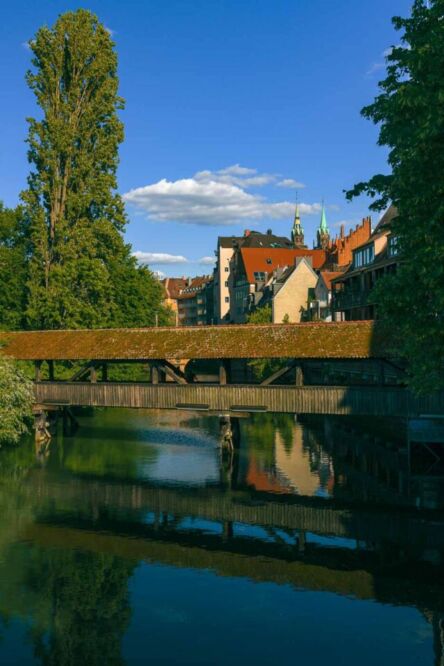 There are several wooden bridges crossing from one side to the other in the heart of Nuremberg. For one of the most romantic and photogenic river views, you have to find the Henkersteg, a historic wooden walkway spanning the Pegnitz River.