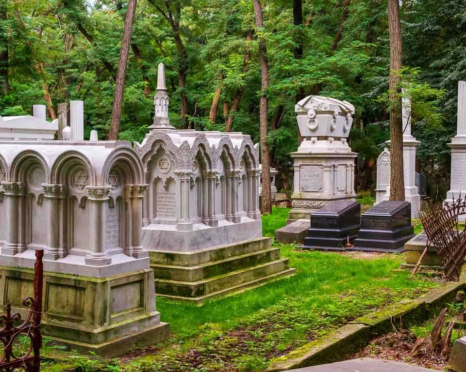 It is the Okopowa Street Jewish Cemetery. Spanning a bit over 33 hectares and containing upwards of 250,000 graves, it stands as the largest Jewish cemetery in Poland and one of the largest in Europe. There is a remarkable void in the landscape of the capital, where pre-war Warsaw is mainly unaltered and where moss, carved stone, and deep silence all serve as direct windows into the past.
